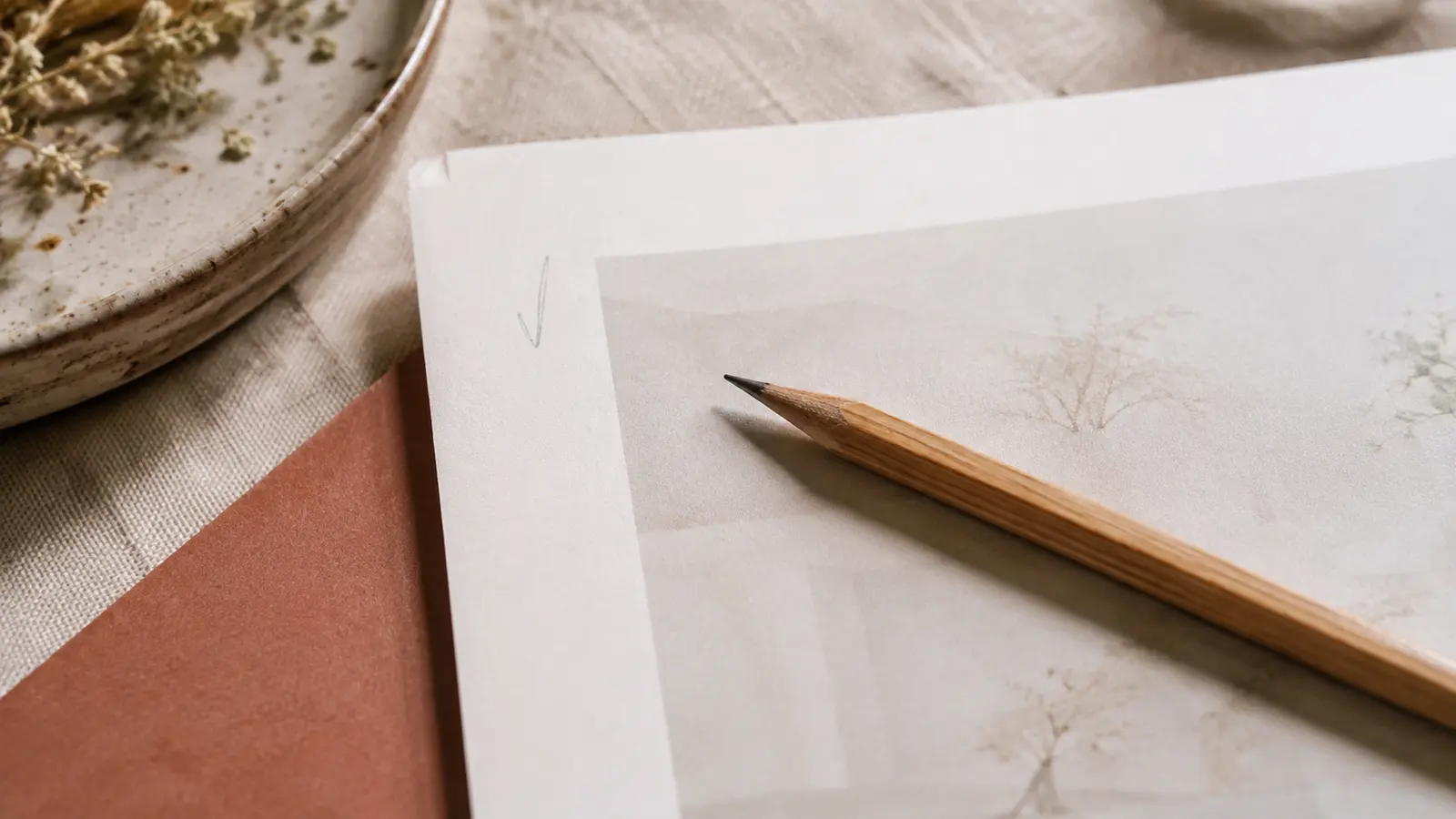 A proofreader's pencil resting on a printed page
